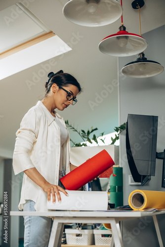 Woman designer with colorful paper at an office