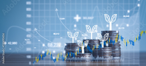 Close up of stacking of growth up coins with Double exposure of chart graph financial with night bokeh background for finance and business ,capital banking and investment,coin stock market concept. photo