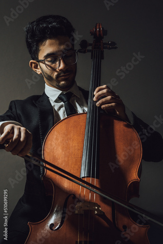 Classic cello player performing with suit