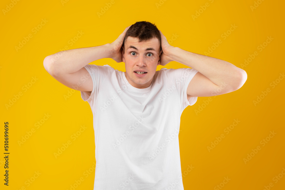 Shocked Millennial Man Touching Head Looking At Camera, Yellow Background Shocked Millennial Man Touching Head Looking At Camera, Yellow Background
