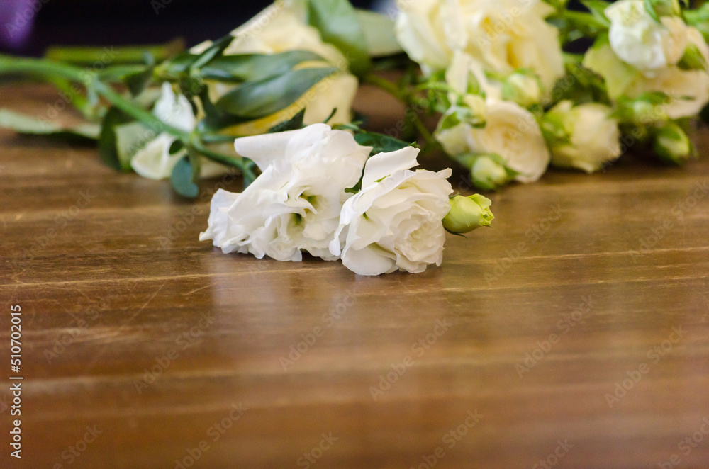 white roses on a wooden table white roses on a wooden table