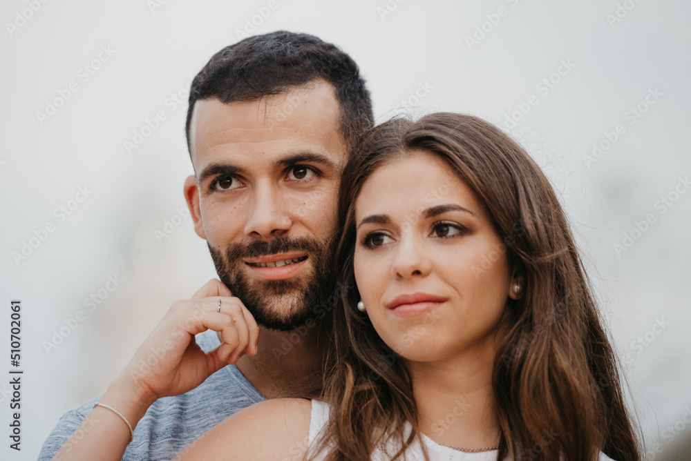 A close portrait of a Latin girl who is stroking the face of her Hispanic boyfriend near the lighthouse in Spain. A happy couple of tourists in the evening in Valencia. A close portrait of a Latin girl who is stroking the face of her Hispanic boyfriend near the lighthouse in Spain. A happy couple of tourists in the evening in Valencia.