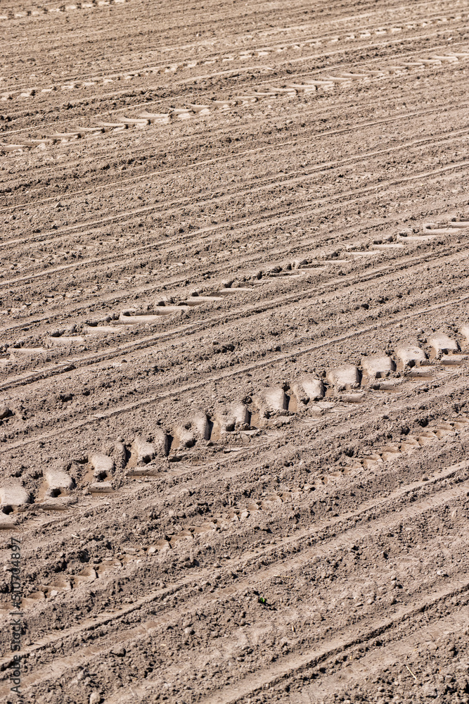 plowed soil in an agricultural field during tillage
