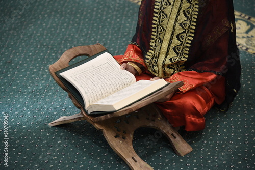 The Holy Qur’an on a wooden stand in the mosque, prayer and supplication in the mosque, worship and getting closer to God