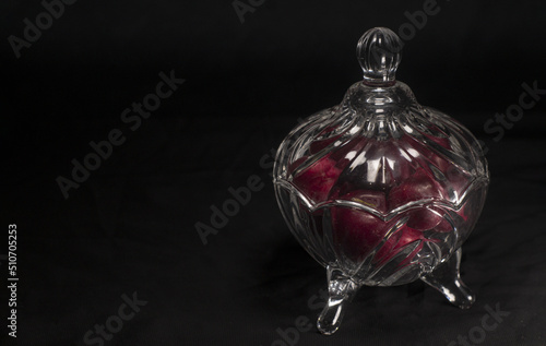 plums inside a glass container with black background
