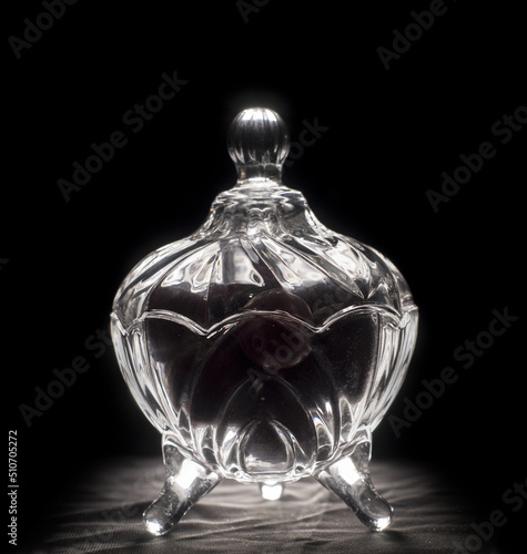 plums inside a glass container with black background