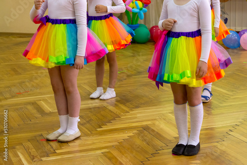 A group of girls in kindergarten performs in bright skirts