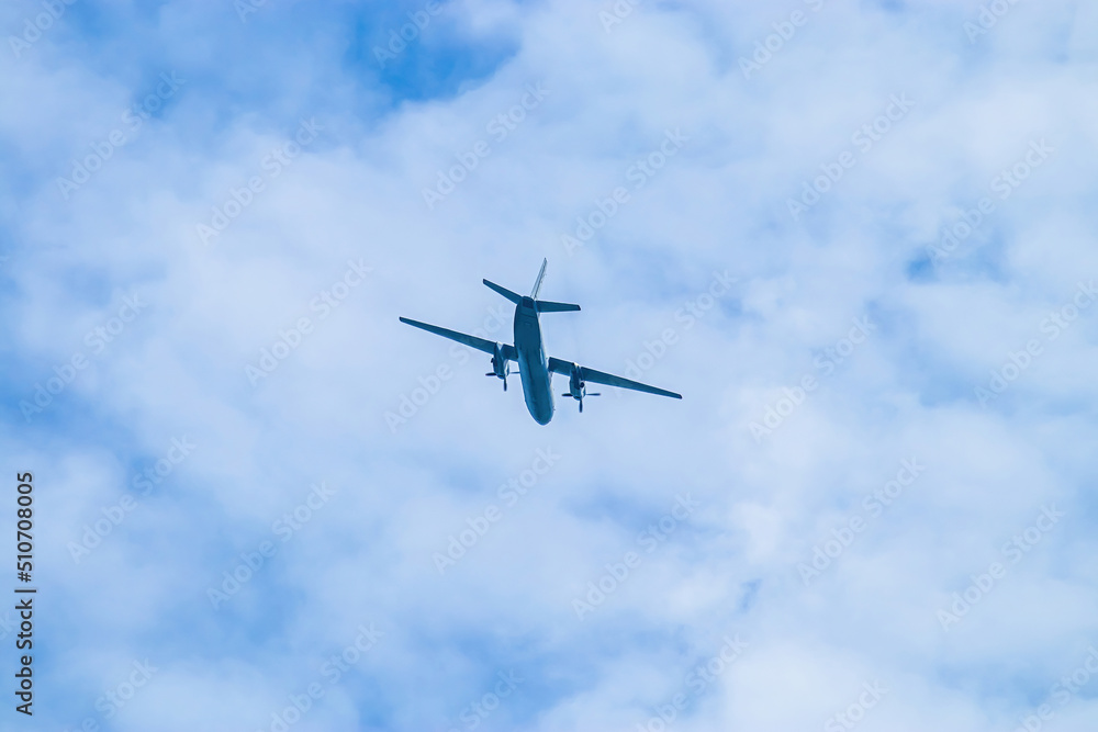 Airplane in blue sky. Air cargo transportation. Plane is flying Airplane in blue sky. Air cargo transportation. Plane is flying