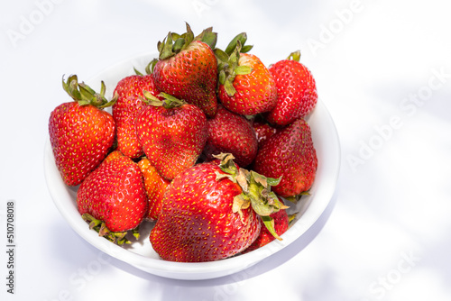 Bowl of strawberries on a white background