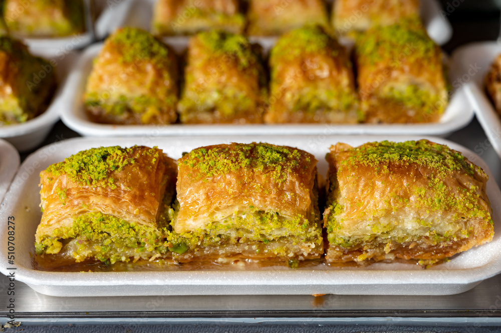 Turkish or arabic sweet dessert, baklava made from filo pastry, filled with chopped pistachio nuts and sweetened with syrup or honey. Turkish or arabic sweet dessert, baklava made from filo pastry, filled with chopped pistachio nuts and sweetened with syrup or honey.