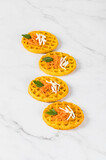 Appetizer round carrot waffles on a light background