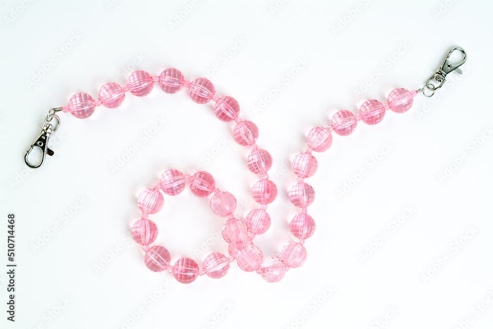 Obraz premium pink necklace on white background isolated