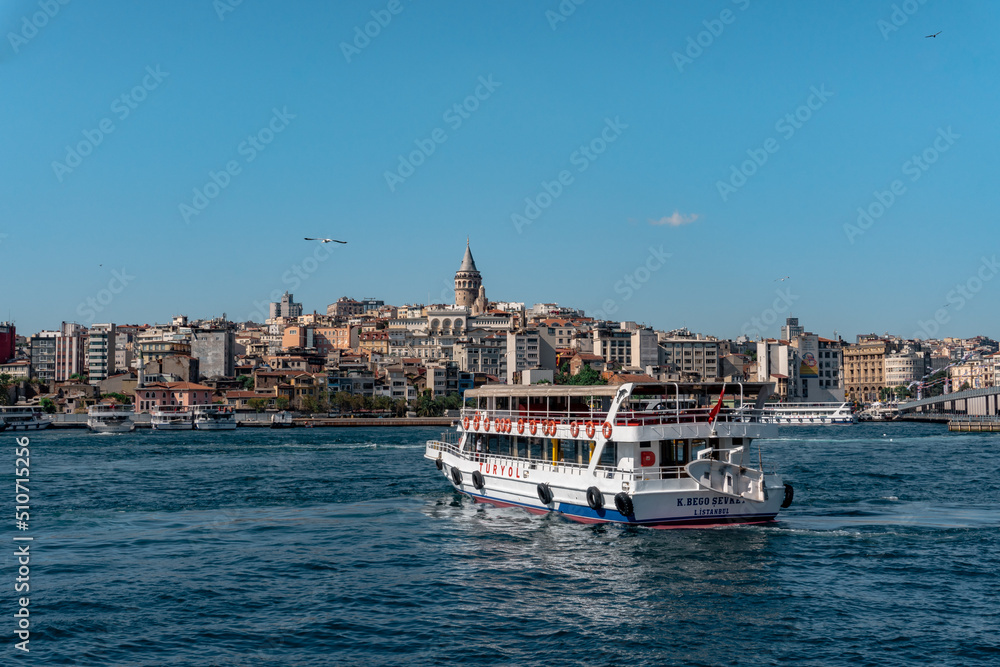 Boat crossing Golden Horn, with Galata Tower in the background, at Turkey