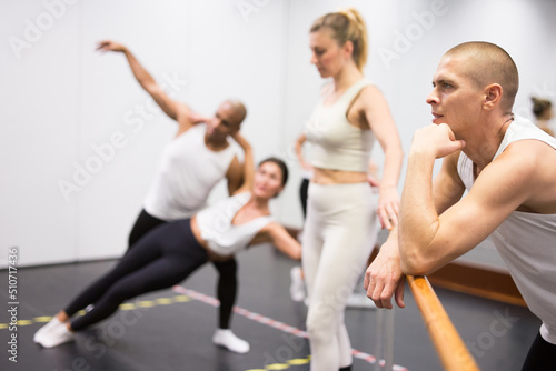 Male dancer oversees professional ballerina in the dance hall. High quality photo