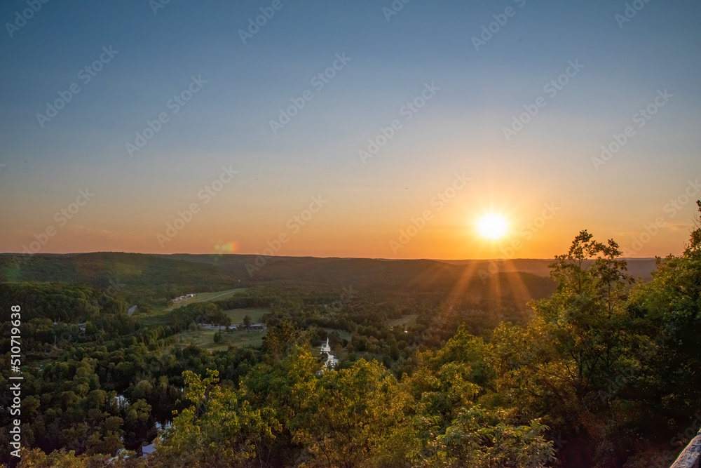 The sun sets over the small cottage town of Bancroft, Ontario on a beautiful summer evening, as seen from the Eagle's Nest Lookout.
