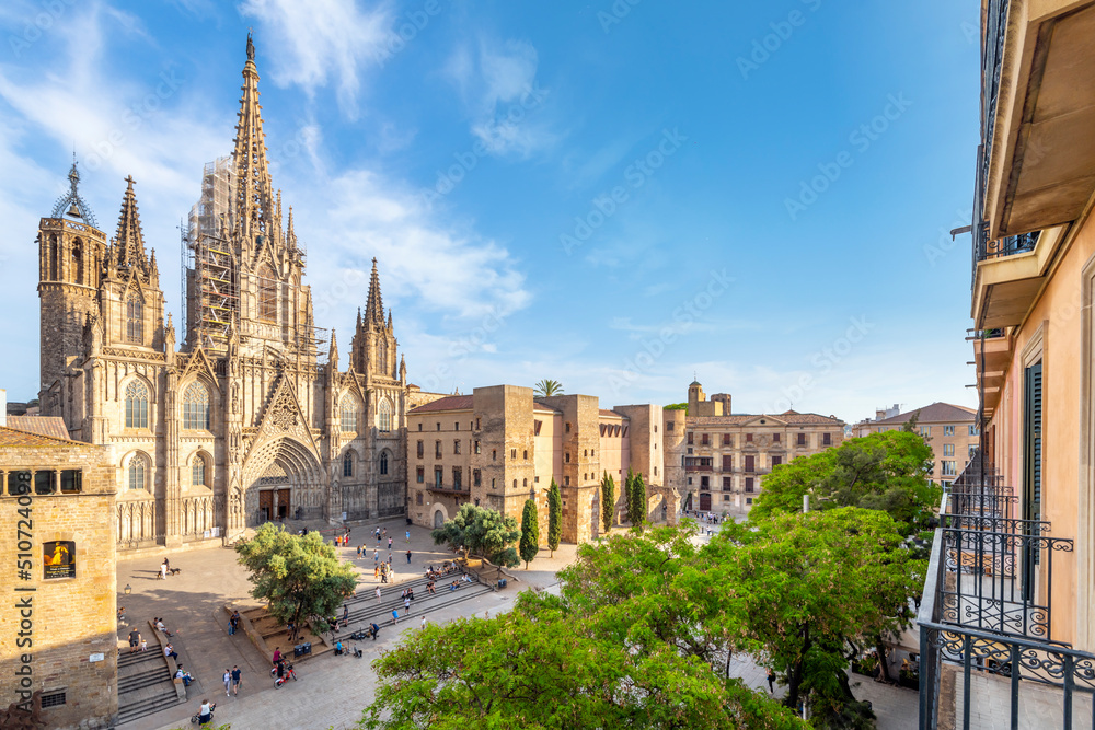 View of the Gothic Cathedral of the Holy Cross and Saint Eulalia, also known as Barcelona Cathedral from a balcony terrace across the plaza in the Catalonia city of Barcelona, in Southern Spain. - obrazy, fototapety, plakaty 