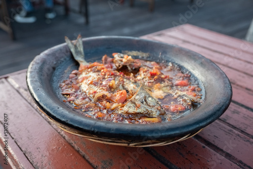 processed chili sauce made from tomatoes and chilies cooked with fresh fish on a clay plate, a typical food from Indonesia, Bontang, East Kalimantan, in Indonesian this food is called " gami bawis "