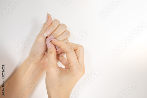 Female nail weakness damage from gel polish coating, Fingernail manicure.