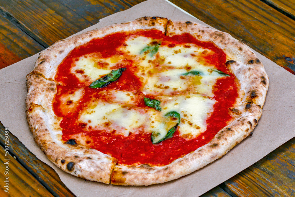 Pizza Margherita on rustic wooden table