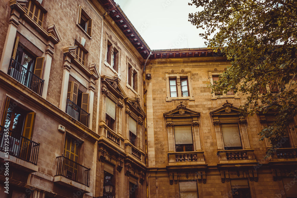 Old building facade, Palma de Mallorca, Spain. Old windows closeup of building in Spain. Facade of an ancient building
