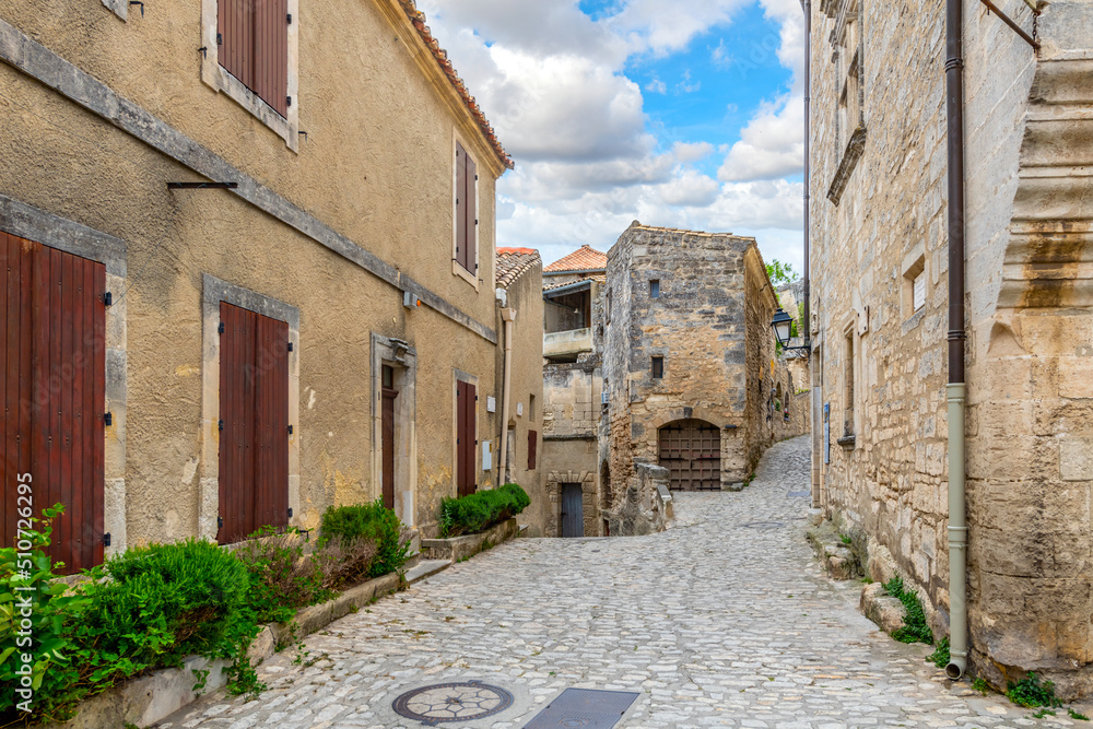 A typical stone street through the historic medieval village of Les Baux-de-Provence in the Alpilles Mountains of the Provence-Alpes-Cote d'Azur region of Southern France.