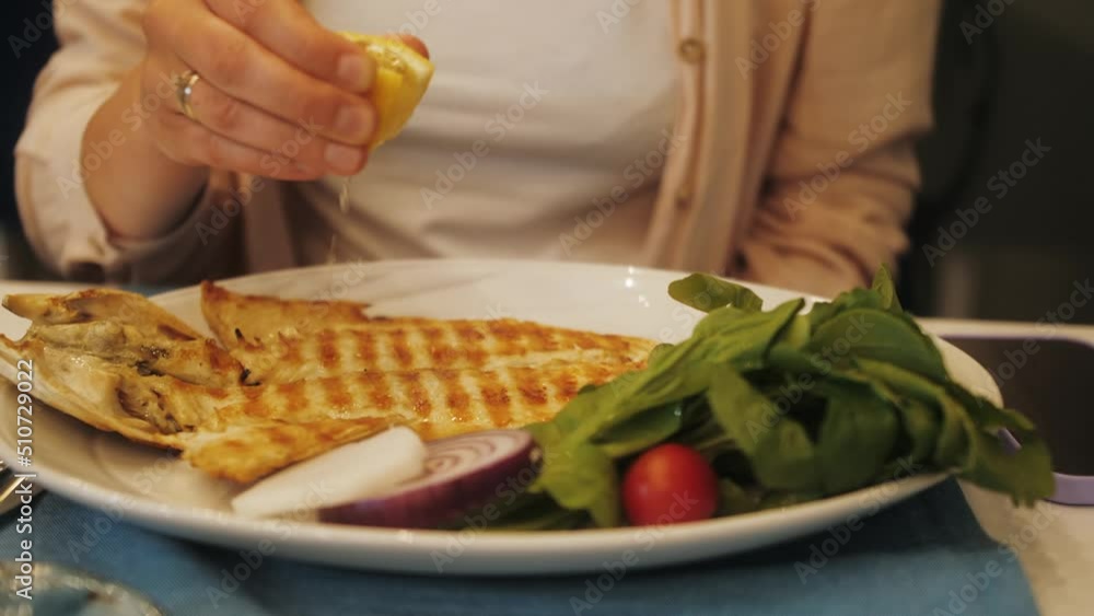 Grilled tasty white fish on white plate with vegetables Grilled tasty white fish on white plate with vegetables