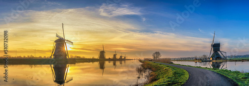 Rotterdam Netherlands, sunrise panorama nature landscape of Dutch Windmill at Kinderdijk Village photo