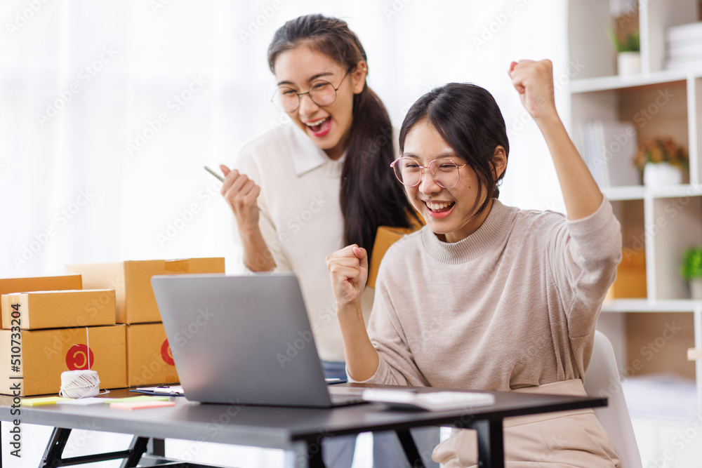 Two Young Asian women are happy and excited after a new order from SME customer, commercial checking, online marketing, Entrepreneur packing boxes, SME sellers, and freelance online sales concept, Two Young Asian women are happy and excited after a new order from SME customer, commercial checking, online marketing, Entrepreneur packing boxes, SME sellers, and freelance online sales concept,