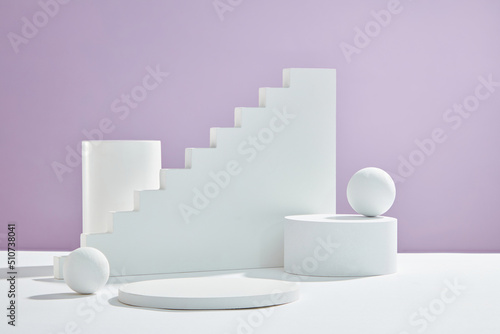 Front view of white podium and stairway with blank space in purple background abstract content