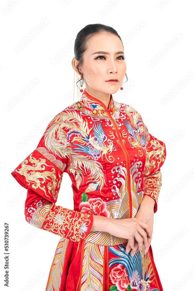 Fototapeta premium Portrait of a young asian Chinese female lady model wearing red traditional vintage wedding costume smiling and posing with different poses and gestures