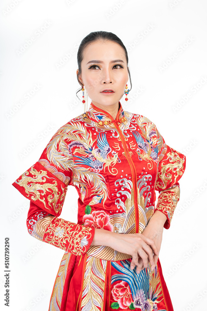 Portrait of a young asian Chinese female lady model wearing red traditional vintage wedding costume smiling and posing with different poses and gestures 