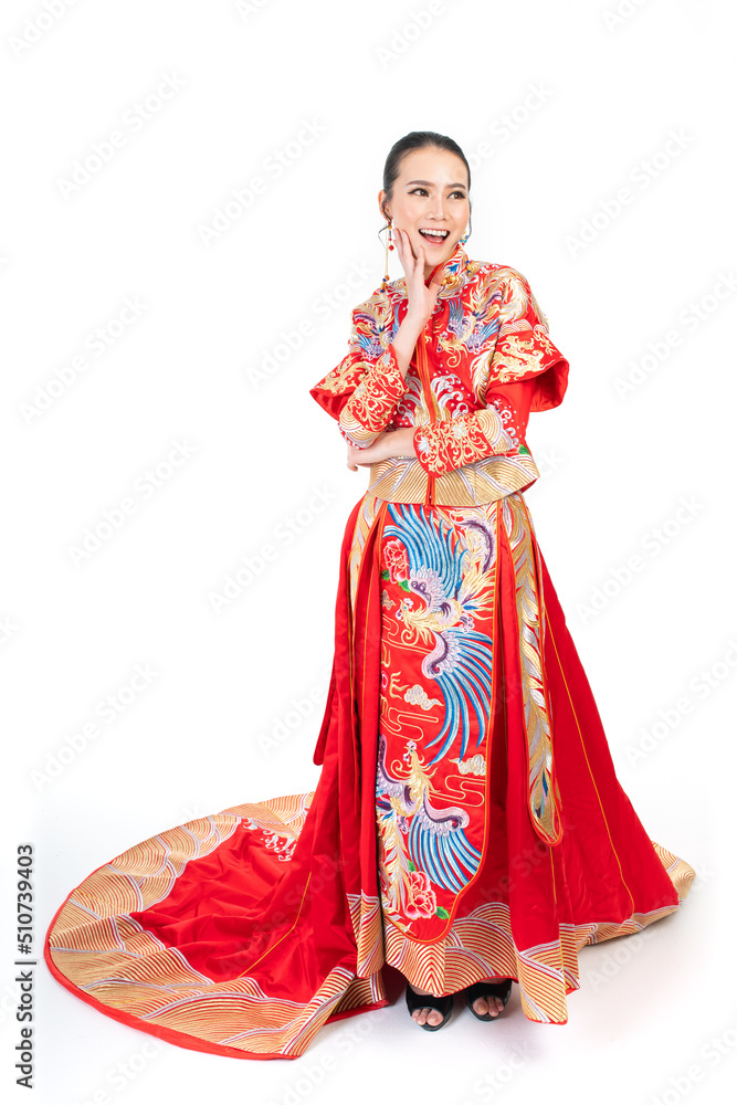 Portrait of a young asian Chinese female lady model wearing red traditional vintage wedding dress costume smiling and posing with different poses and gestures Portrait of a young asian Chinese female lady model wearing red traditional vintage wedding dress costume smiling and posing with different poses and gestures