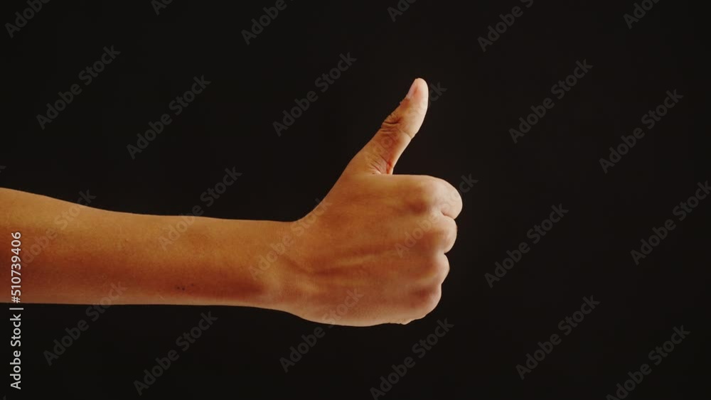 African american man showing like gesture with fingers isolated on black background. Male person holding thumb up. African american man showing like gesture with fingers isolated on black background. Male person holding thumb up.