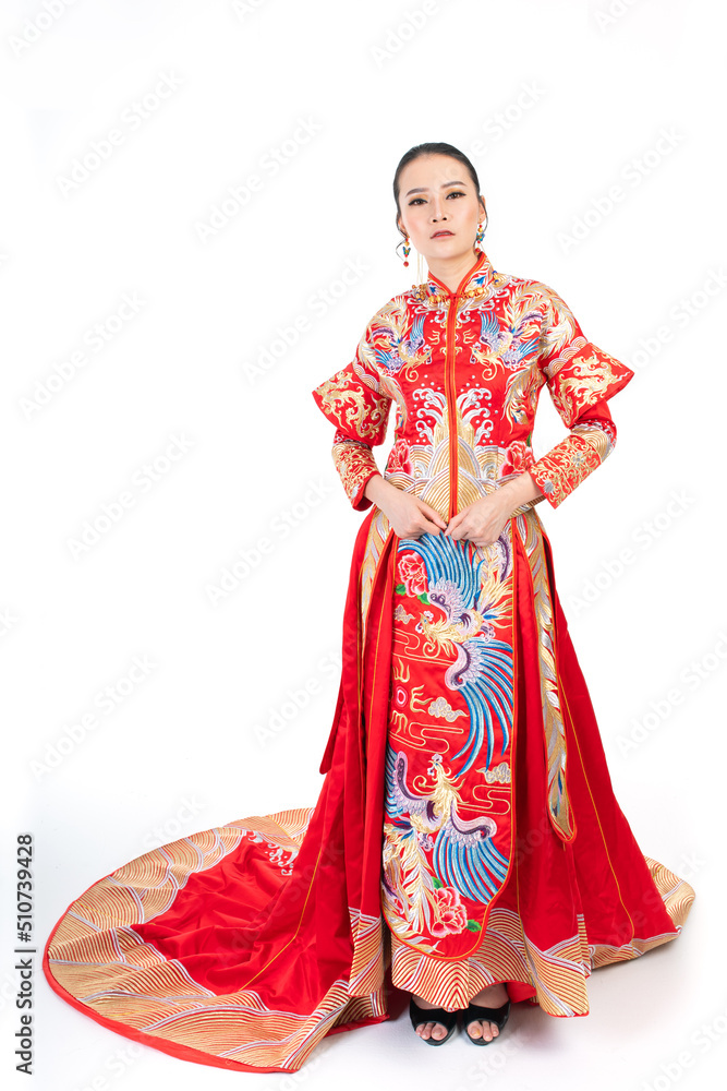 Portrait of a young asian Chinese female lady model wearing red traditional vintage wedding dress costume smiling and posing with different poses and gestures Portrait of a young asian Chinese female lady model wearing red traditional vintage wedding dress costume smiling and posing with different poses and gestures