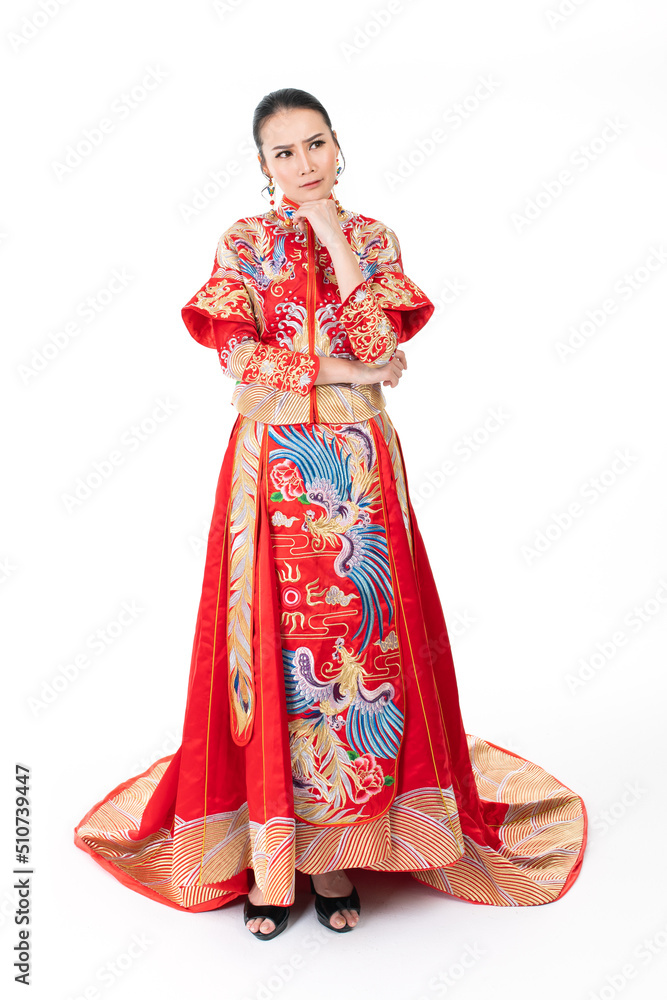Portrait of a young asian Chinese female lady model wearing red traditional vintage wedding dress costume smiling and posing with different poses and gestures Portrait of a young asian Chinese female lady model wearing red traditional vintage wedding dress costume smiling and posing with different poses and gestures
