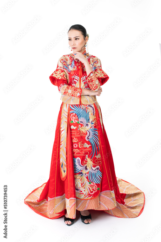 Portrait of a young asian Chinese female lady model wearing red traditional vintage wedding dress costume smiling and posing with different poses and gestures 