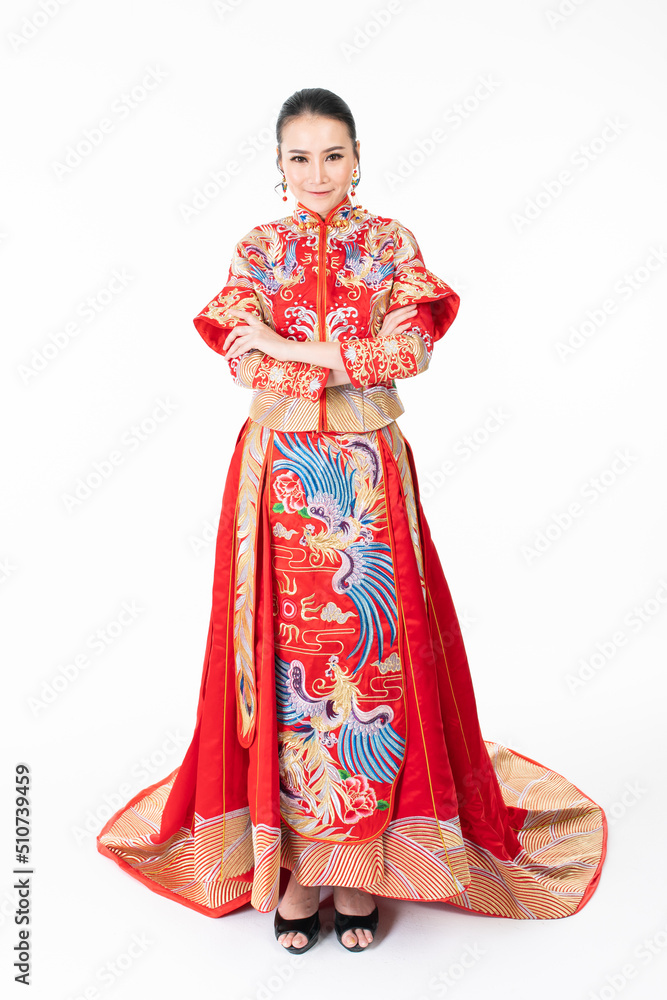 Portrait of a young asian Chinese female lady model wearing red traditional vintage wedding dress costume smiling and posing with different poses and gestures Portrait of a young asian Chinese female lady model wearing red traditional vintage wedding dress costume smiling and posing with different poses and gestures