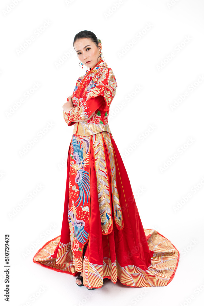 Portrait of a young asian Chinese female lady model wearing red traditional vintage wedding dress costume smiling and posing with different poses and gestures Portrait of a young asian Chinese female lady model wearing red traditional vintage wedding dress costume smiling and posing with different poses and gestures