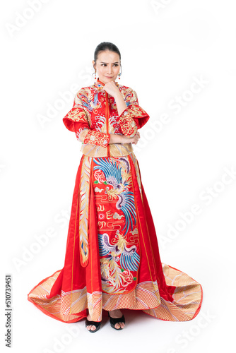 Portrait of a young asian Chinese female lady model wearing red traditional vintage wedding dress costume smiling and posing with different poses and gestures  © asean studio