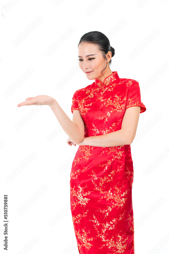 Asian Chinese Woman wearing red color traditional Chinese costume Cheongsam looking at her hand Asian Chinese Woman wearing red color traditional Chinese costume Cheongsam looking at her hand