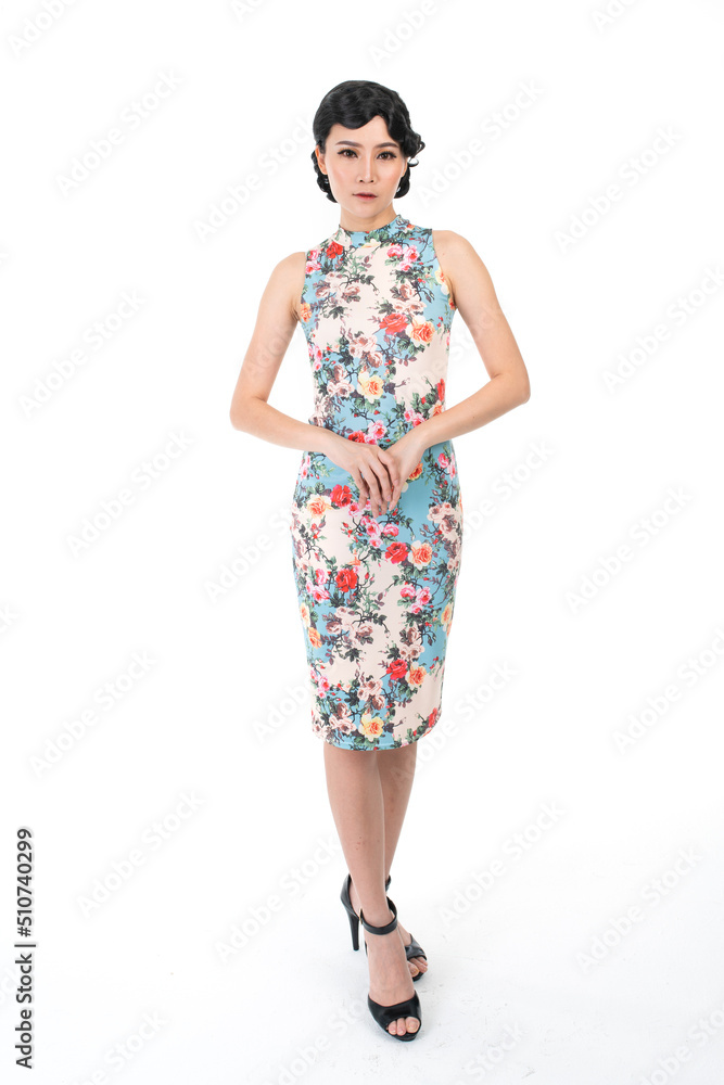 Portrait of a young asian Chinese female lady model wearing a patterned traditional vintage costume Cheongsam smiling and posing with different poses and gestures Portrait of a young asian Chinese female lady model wearing a patterned traditional vintage costume Cheongsam smiling and posing with different poses and gestures