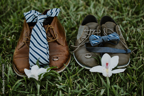 two grooms shoes on grass for wedding