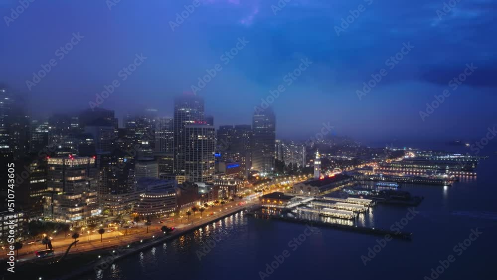 Night view of big city, San Francisco cityscape. Aerial business offices and residential buildings in clouds. Night view of San Francisco downtown, California state, bay area of Silicon valley America Night view of big city, San Francisco cityscape. Aerial business offices and residential buildings in clouds. Night view of San Francisco downtown, California state, bay area of Silicon valley America