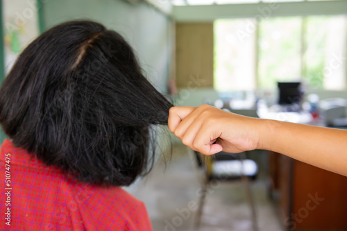 Schoolgirl pulling her friend's hair