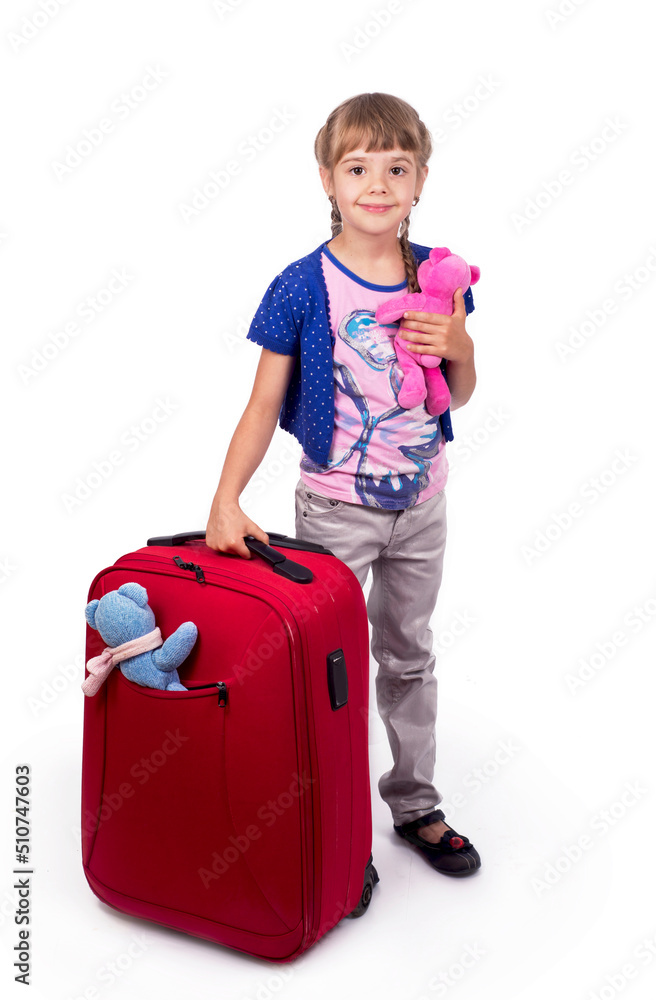 Traveling with children. Tourism. Cute little girl and big red suitcase isolated on white background Traveling with children. Tourism. Cute little girl and big red suitcase isolated on white background