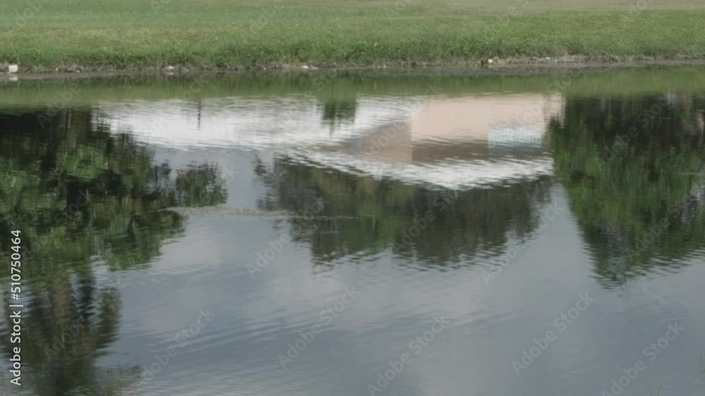 Reflections in the creek canal, waves in the creek canal, ripples in the canal, Beautiful day at the creek, grass at the creek canal Reflections in the creek canal, waves in the creek canal, ripples in the canal, Beautiful day at the creek, grass at the creek canal