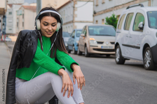 happy hispanic latin woman in the street with headphones