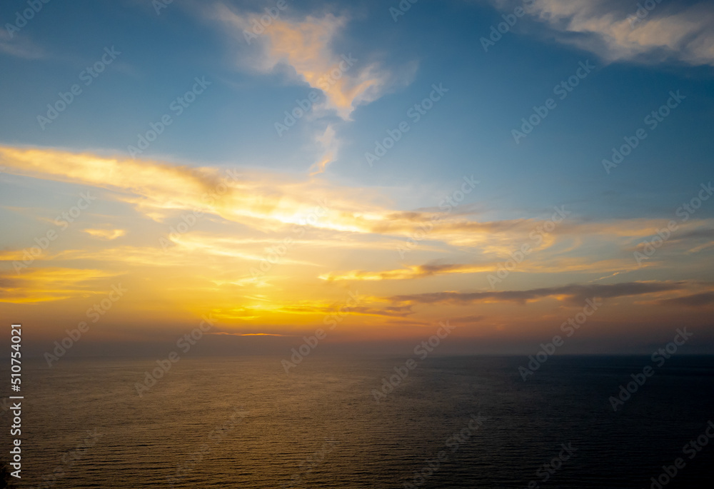 A sea sunset with cloudy sky.