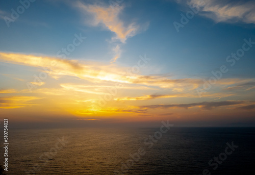 A sea sunset with cloudy sky. © Ming