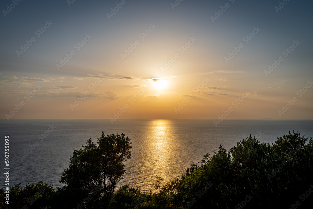 A beautiful sea sunset with the sun casting light reflection on the sea. Lefkada island, Greece